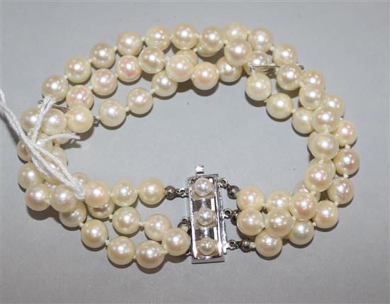 A triple strand cultured pearl bracelet with 14ct gold and cultured pearl set rectangular clasp, 20cm approx.